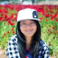 Shou Li in front of flower garden