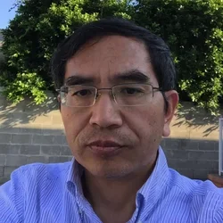 Yonggang Zhou in front of wall